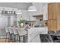 Elegant kitchen with a large waterfall island, breakfast bar, and stainless steel appliances at 154 Nine Mile Creek Dr, Las Vegas, NV 89138