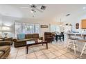 Open-concept living area with a ceiling fan that seamlessly connects to the dining area at 1633 Broken Feather Dr, North Las Vegas, NV 89031