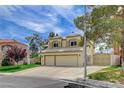 Beautiful home with a well-maintained lawn, mature trees, and a convenient two-car garage at 2073 Sapphire Valley Ave, Henderson, NV 89074