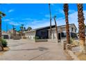 Modern two-story house boasting a spacious driveway and desert landscaping with mature palm trees at 2685 S Tenaya Way, Las Vegas, NV 89117