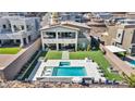 Expansive backyard with a pool, spa, patio, and lush artificial grass, perfect for outdoor living at 270 Shaded Canyon Dr, Henderson, NV 89012