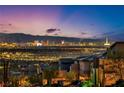 Panoramic city views at night, showcasing the vibrant Las Vegas skyline and surrounding mountains at 270 Shaded Canyon Dr, Henderson, NV 89012