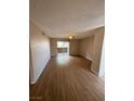 Cozy living room with neutral walls and wood-look floors featuring a sliding door for natural light at 2750 S Durango Dr # 1080, Las Vegas, NV 89117