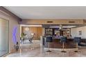 Open bar area with stools, counterspace, mirrored shelving and views of dining area at 2777 Paradise Rd # 1801, Las Vegas, NV 89109