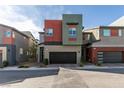 A modern two-story home with a two-car garage showcasing its unique contemporary design and curb appeal at 3217 Bertonico Ave, Henderson, NV 89044