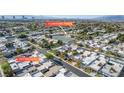 An elevated view showing homes and community areas including a tennis court and a pool at 3371 Royce Ct, Las Vegas, NV 89121