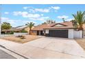 Attractive single-story house with a dark garage door, complemented by palm trees at 3409 El Cortez Ave, Las Vegas, NV 89102