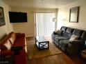 Inviting living room featuring hardwood floors, couch, loveseat, and mounted TV at 3550 Bay Sands Dr # 2016, Laughlin, NV 89029