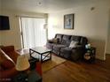 Comfortable living room with hardwood floors, couch, love seat, and sliding door at 3550 Bay Sands Dr # 2016, Laughlin, NV 89029
