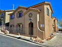 Two-story townhome featuring a well-maintained desert landscape and a red-tiled roof, with a secure fence at 4046 Sparrow Rock St, Las Vegas, NV 89129