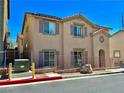 Two-story home featuring neutral-toned stucco, a red-tiled roof, decorative shutters, and secure fencing at 4046 Sparrow Rock St, Las Vegas, NV 89129