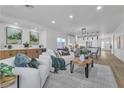 Spacious living room featuring modern decor, a large sofa, and an open view into the kitchen at 4434 Verdiccio Ave, Las Vegas, NV 89141