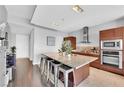 Bright kitchen features an island with seating, modern appliances, and dark wood cabinets and drawers at 4471 Dean Martin Dr # 2204, Las Vegas, NV 89103