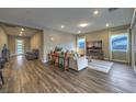 Bright living room with hardwood floors, neutral tones, and comfortable seating arrangement at 51 Reflection Cove Dr, Henderson, NV 89011