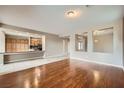Open-concept living space with hardwood floors flowing into the adjoining kitchen at 5505 Criollo Dr, Las Vegas, NV 89122