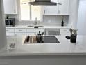 Modern kitchen with white cabinetry, stainless steel appliances, and quartz countertops at 620 N 16Th St, Las Vegas, NV 89101
