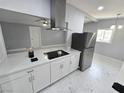 Bright kitchen with stainless steel appliances, white cabinets, and modern range hood at 620 N 16Th St, Las Vegas, NV 89101
