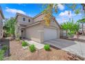 Attractive home showcasing a two-car garage, neat landscaping, and a charming exterior at 6217 Lone Cypress Ct, Las Vegas, NV 89141