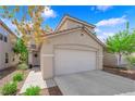 Picture of a home featuring a two-car garage, desert landscaping, and a tidy front entrance at 6217 Lone Cypress Ct, Las Vegas, NV 89141