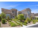 Beautiful two-story home with landscaped front yard, stone accents, and a two-car garage at 631 Coriander Canyon Ct, Las Vegas, NV 89138