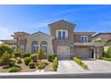 Elegant two-story home with well-manicured landscaping and a spacious two-car garage at 631 Coriander Canyon Ct, Las Vegas, NV 89138