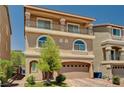 Beautiful home with balcony, arched windows, a two car garage, and green landscaping at 6516 Austin Hope Ave, Las Vegas, NV 89118