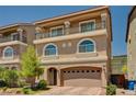 Charming two-story home with a balcony, arched windows, and a brick driveway at 6516 Austin Hope Ave, Las Vegas, NV 89118