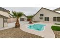 Backyard with small pool, surrounded by gravel and palm trees at 6549 Gazelle Dr, Las Vegas, NV 89108