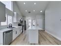 Bright kitchen features an island, stainless steel appliances, and light wood floors at 6549 Gazelle Dr, Las Vegas, NV 89108
