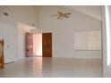Bright living room featuring tile floors, vaulted ceilings and an open entry at 7720 Leavorite Dr, Las Vegas, NV 89128