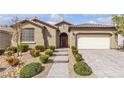 Beautifully landscaped front exterior features desert landscaping, a tile roof, and a paver driveway at 8393 Canyon Crevasse St, Las Vegas, NV 89166