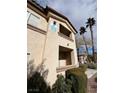 Condo exterior featuring a two story facade and partial view of the community at 8501 W University Ave # 1128, Las Vegas, NV 89147