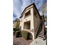 Condo exterior shows a two story building, stairs, walkway, and partial view of the community at 8501 W University Ave # 1128, Las Vegas, NV 89147