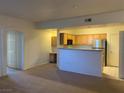 A cozy living room open to a modern kitchen, perfect for entertaining and comfortable living at 8555 W Russell Rd # 1078, Las Vegas, NV 89113