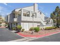 Charming two-story condo boasting a rooftop deck, stucco facade, and low-maintenance landscaping at 8932 Antioch Way, Las Vegas, NV 89117