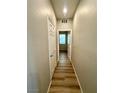 Hallway features clean white doors and wood flooring at 9136 Cocowoods Pl, Las Vegas, NV 89148