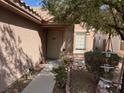 Inviting front porch with manicured landscaping, potted plants, and decorative garden elements at 9436 Silvaner Ct, Las Vegas, NV 89123