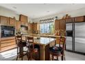 Well-equipped kitchen featuring an island with granite countertops, stainless steel appliances, and ample cabinet space at 948 Mill Run Creek Ave, Henderson, NV 89002