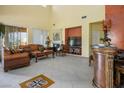 Spacious living room with tall ceilings, fireplace, decorative art niches, and tile floors in a modern design at 948 Mill Run Creek Ave, Henderson, NV 89002