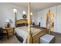 Elegant main bedroom features a canopy bed and an ensuite bathroom at 948 Mill Run Creek Ave, Henderson, NV 89002