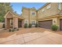 Elegant two-story home with a brick-accented entrance, double garage, and manicured landscaping at 9733 Camden Hills Ave, Las Vegas, NV 89145