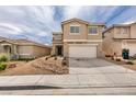 Two-story home featuring a two car garage, low-maintenance desert landscaping, and a modern exterior at 9855 Ashton Pines Ct, Las Vegas, NV 89147