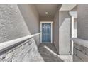 Inviting entryway with a stylish blue front door and stone accents at 1174 King Lark St, Henderson, NV 89011