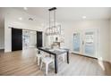 Dining room boasts modern chandelier, direct entry to kitchen and access to outdoor patio at 1917 N Moapa Valley Blvd, Logandale, NV 89021