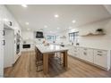 Modern kitchen featuring white cabinets, stainless steel appliances, and a large center island with seating at 1917 N Moapa Valley Blvd, Logandale, NV 89021