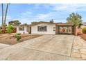Attractive single-story home featuring desert landscaping and a covered parking area at 2021 N Michael Way, Las Vegas, NV 89108