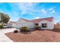 Inviting single-story home with a tile roof, complemented by manicured landscaping and ample parking space at 2117 Mountain Sunset Ave, North Las Vegas, NV 89031