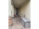 Inviting covered front porch with stylish pavers and seating area, perfect for relaxing outdoors at 2674 Duneville St, Las Vegas, NV 89146