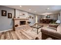 Open-concept living space with brick fireplace, wood floors, and neutral color palette at 2721 Family Ct, Las Vegas, NV 89117