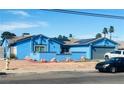 Charming single-story home featuring a blue exterior, desert landscaping, and solar panels at 3664 Rawhide St, Las Vegas, NV 89120